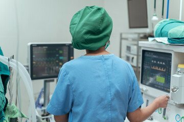 Anesthesiologist monitor the patient condition under general anesthesia during surgery in operation...