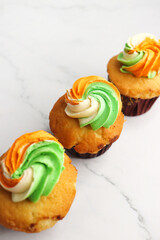 Tiranga Cupcake or Tricolor Cupcake with Indian National Flag colors frosting. saffron or orange, white and green. The concept for Indian happy Independence or Republic day greeting card. copy space.