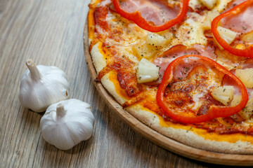 pizza with ham, mozzarella, red pepper and pineapple