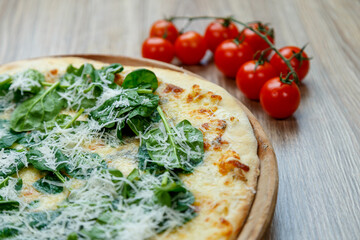 pizza with spinach and mozzarella extra shredded chessee