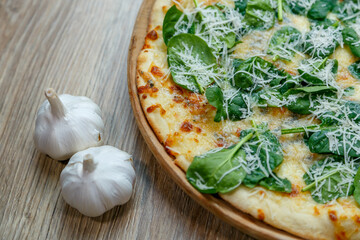 pizza with spinach and mozzarella extra shredded chessee