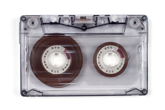 Close-up audio cassette on a white background.