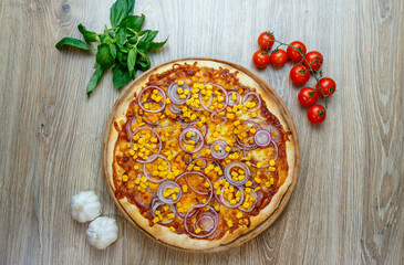 pizza with ham, corn, onion rings and mozzarella