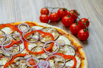 pizza vegetarian with eggplant, zucchini, onion rings and tomato sauce
