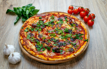 pizza with sausage, ham, salami and parsley
