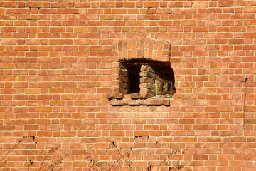 a window like an embrasure in a brick wall
