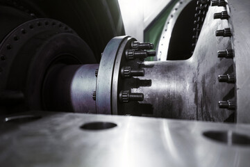 A gas turbine with a compressor rotor and a bolted coupling half