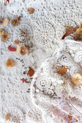Beautiful delicate background of white lace and dry flowers