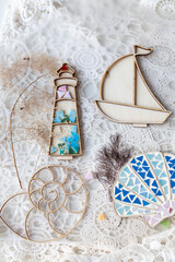 Wooden molds for mosaics in the form of a lighthouse, shells, boat, multi-colored glass on lace