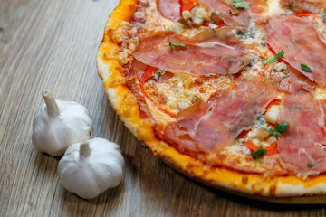 pizza with prosciutto crudo, mushrooms, mozarella, red bell peppers and parsley