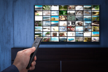 Video on demand service on smart TV. man choosing what to watch on TV at home. Video on demand or...