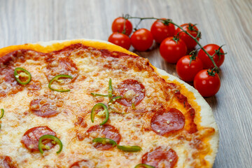 pizza with salami, mozarella, green hot pepper