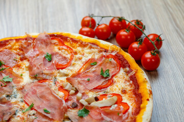 pizza with prosciutto crudo, mushrooms, mozarella, red bell peppers and parsley