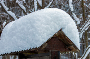 a small wooden roof covered with snow