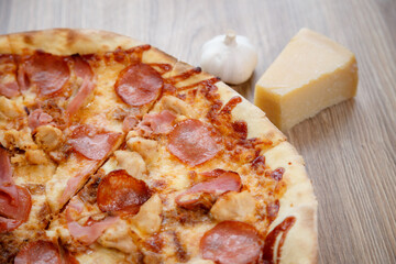 pizza with chicken breast, mozzarella, salami and tomato sauce