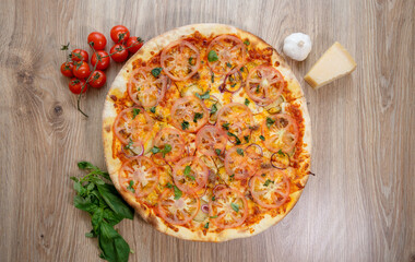 pizza with meat, mozzarella, tomatoes, spinach and tomato sauce