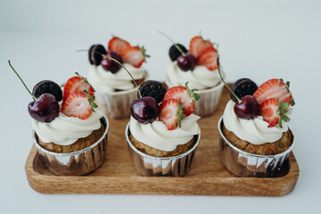 beautiful cupcakes with berries and sprinkles with capsules