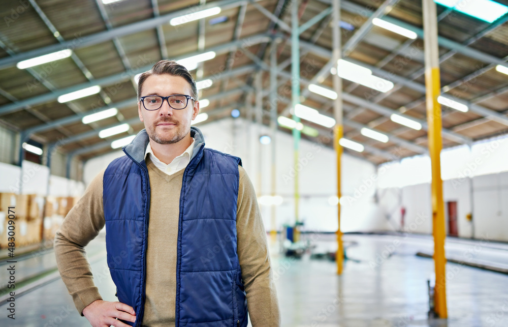 Poster organization is key in distribution. portrait of a man working in a distribution warehouse.