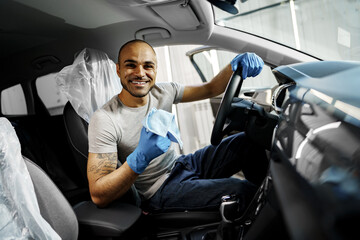 A man cleaning car interior, car detailing in Carwash service