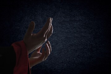 Praying hands on dark background concept for religion and human