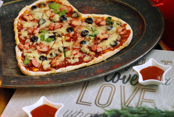 pizza with vegetables. Heart shaped Pizza. Italian food. St Valentin's Day celebration. Romantic dinner. Love background. Creative dish 