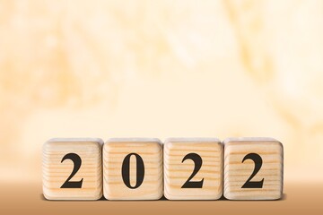 Flipping wooden cubes blocks placed on table. New year and holiday concept.