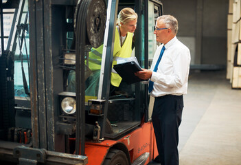 Fototapeta na wymiar Listen and learn from the best. A manager giving orders to an employee who's sitting on a forklift..