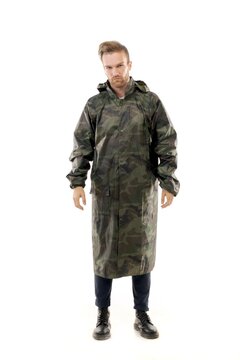 A middle-aged white man wearing a military camouflage raincoat standing over isolated white background looks happy. Worker concept.