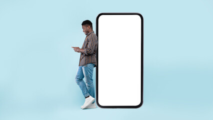 Black man leaning on white blank smartphone screen, using cellphone