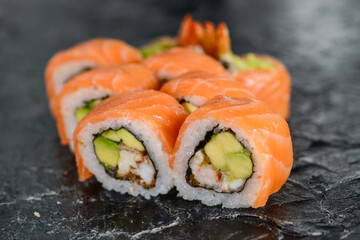sushi rolls philadelphia original on black background
