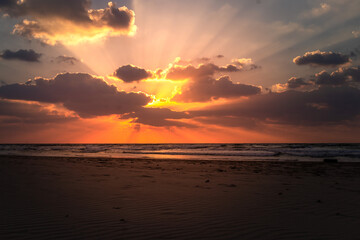 Sea sunset sand Israel. Low angle view of the red sand patterns at the beach at sunset.