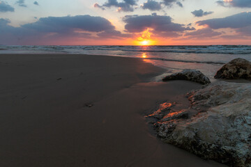 Sea sunset sand Israel. Low angle view of the red sand patterns at the beach at sunset.