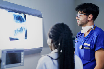 Whats happening inside the chest. Shot of a team of surgeons discussing a patients x rays during...