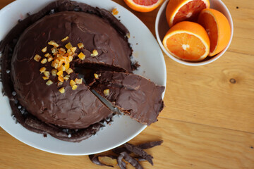 Cut Italian  Zuccotto cake made with chocolate sponge cake ,chocolate and orange cream on plate on wooden table