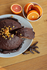 Cut Italian  Zuccotto cake made with chocolate sponge cake ,chocolate and orange cream on plate on wooden table