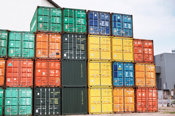 Containers carrying costly cargo. A photo of colorful containers stacked on top of one another..