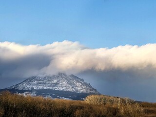 Fototapeta premium Natural background, landscape mountain top in clouds and blue clear sky