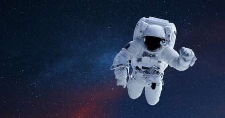 Spaceman flies in open space with stars and galaxies. Copy space for design and text.