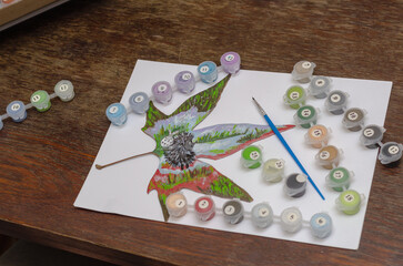Drawing with paints on dry leaves of trees. Creativity, painting