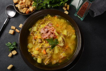 Lentil pea soup garnish with bacon, fried onion and croutons