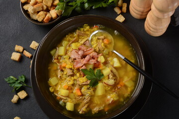 Lentil pea soup garnish with bacon, fried onion and croutons