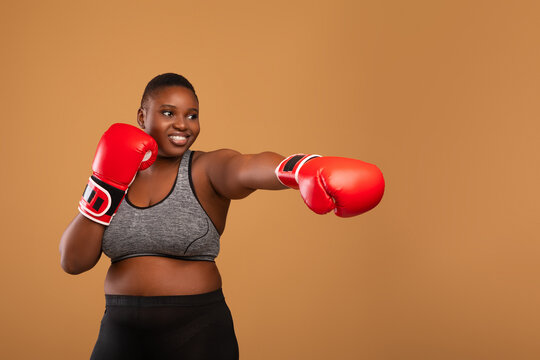 Young Black Woman Boxing Wearing Red Gloves At Studio