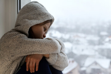 Teenager Trouble Problem.Stress unhappy, angry, lonely, depressed teenager, sad Girl siting at window. Vulnerable teenager. 