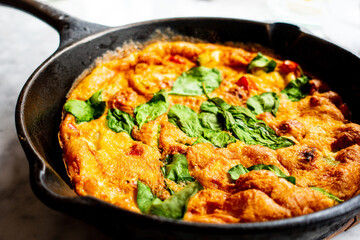 Delicious homemade omelet with vegetables cooked in oven and served in a traditional pan