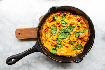 Delicious homemade omelet with vegetables cooked in oven and served in a traditional pan