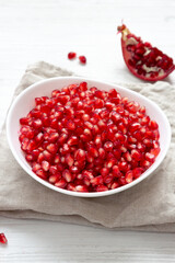 Red Pomegranate Seeds in a White Bowl , low angle view.