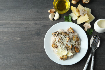 Concept of tasty food with risotto with mushrooms on dark wooden table