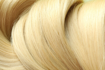 Blonde female hair on whole background, close up