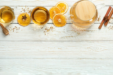 Concept of hot drink with buckwheat tea on white wooden table