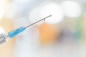 A syringe in front of the blurred background for mandatory vaccination,